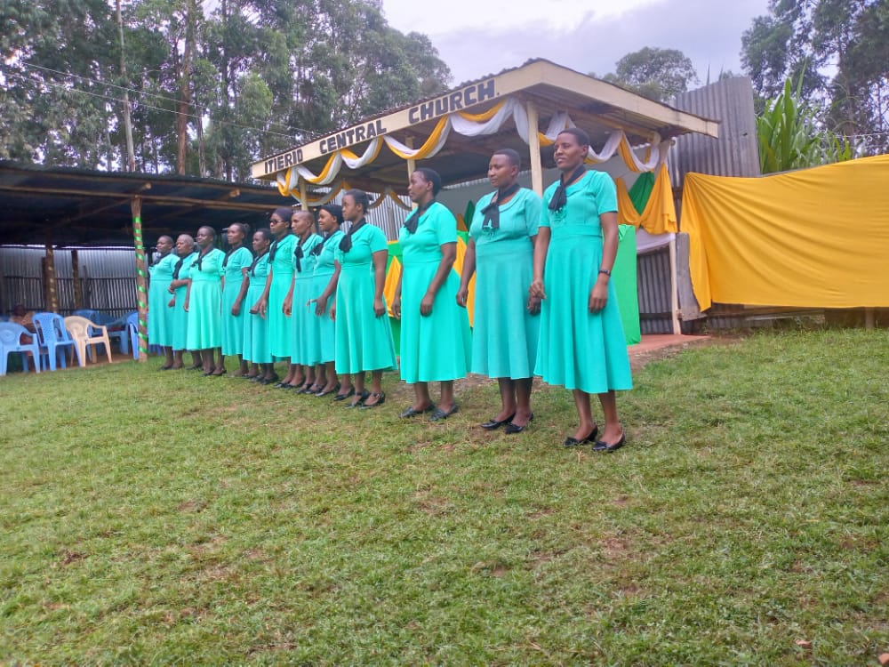 Ladies' section lined up in green uniform before ministering