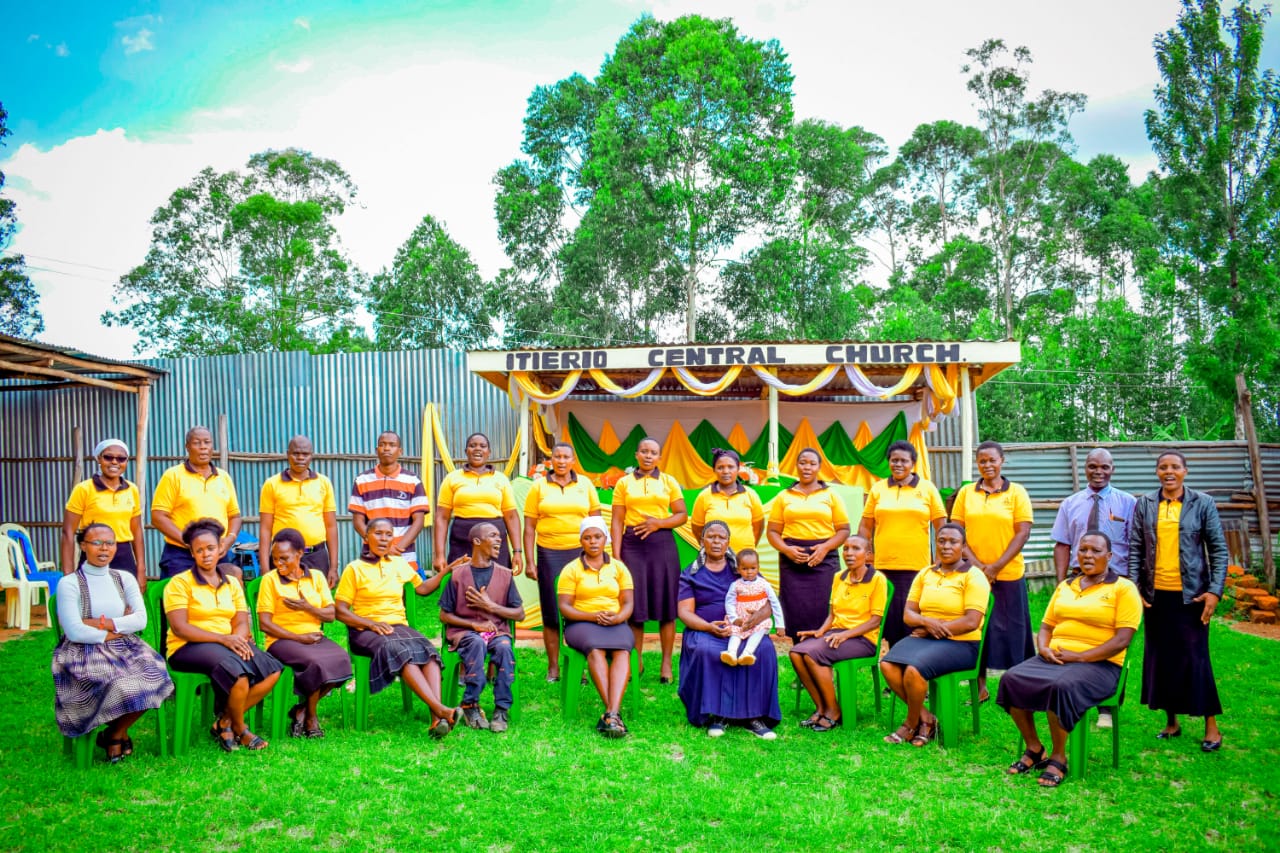 Full choir seated in yellow uniform at Itierio Central Church
